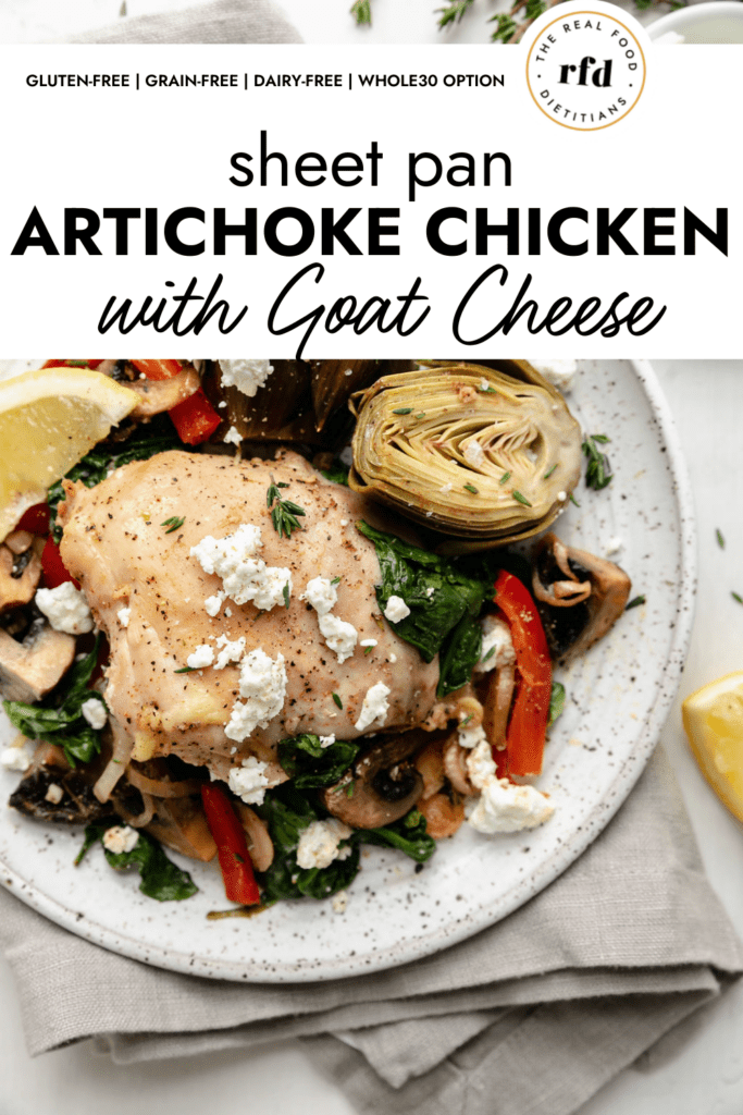 Sheet pan artichoke chicken served on a speckled plate with one chicken thigh, halved artichokes, and roasted veggies, sprinkled with goat cheese. 