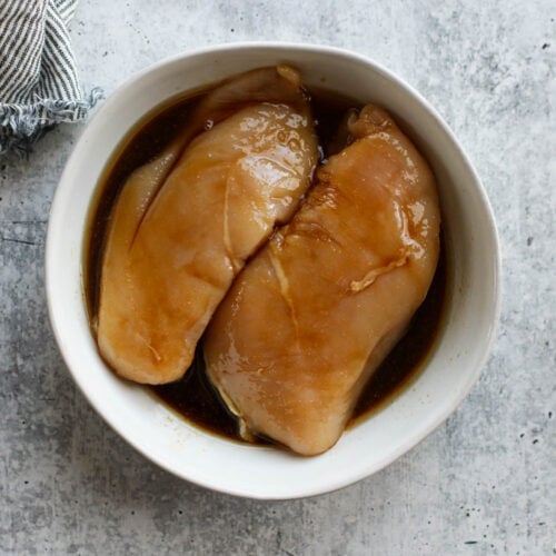 Overhead view of teriyaki chicken marinade in a white bowl.