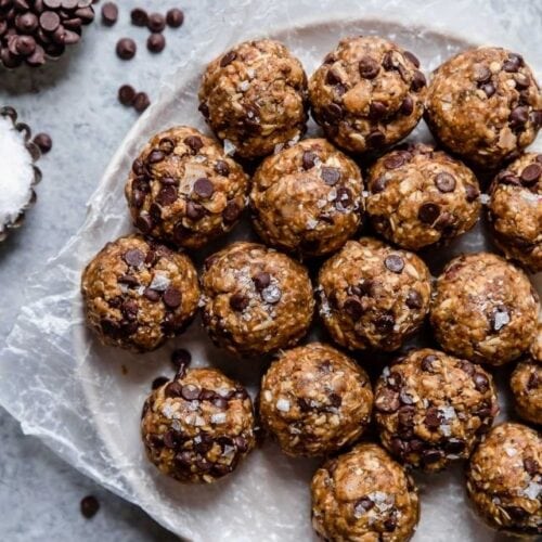 A plate full of peanut butter chocolate chip energy bites for a healthy snack recipe round-up!