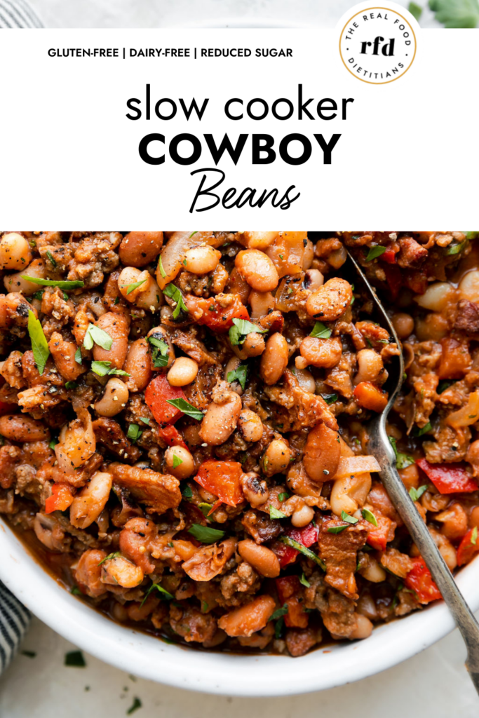 Close up overhead view of slow cooker cowboy beans with ground beef and bacon.