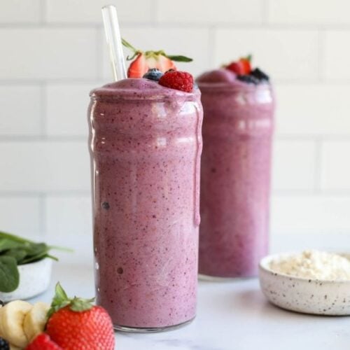 Two tall glasses of berry protein smoothies