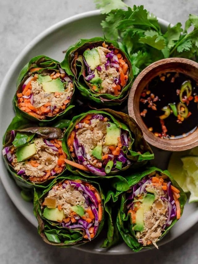 Overhead view of Swiss chard Crockpot Hawaiian Chicken wraps served in white bowl.