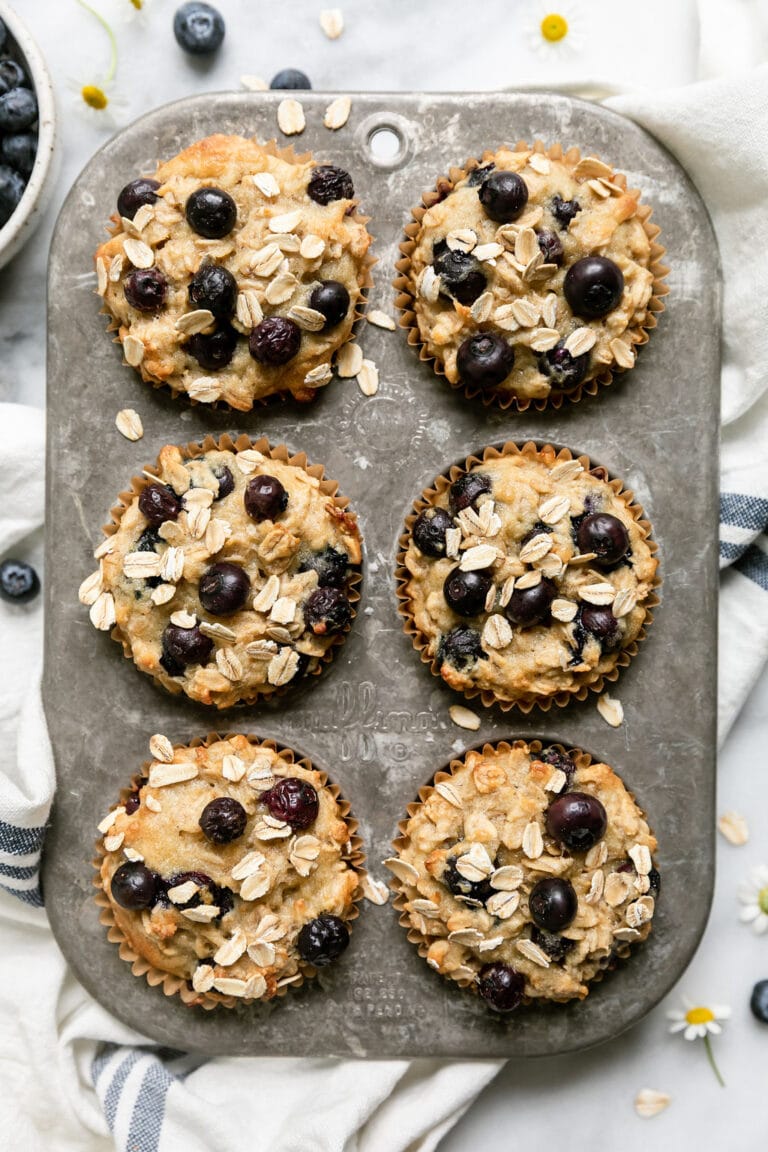 A muffin tin of fresh baked Blueberry Oatmeal Muffins with Yogurt. 