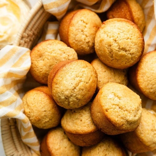 Overhead view of a basket of freshly baked Homemade Cornbread Muffins.