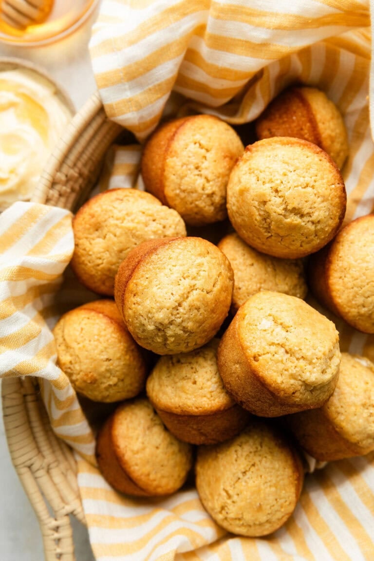 Overhead view of a basket of freshly baked Homemade Cornbread Muffins.
