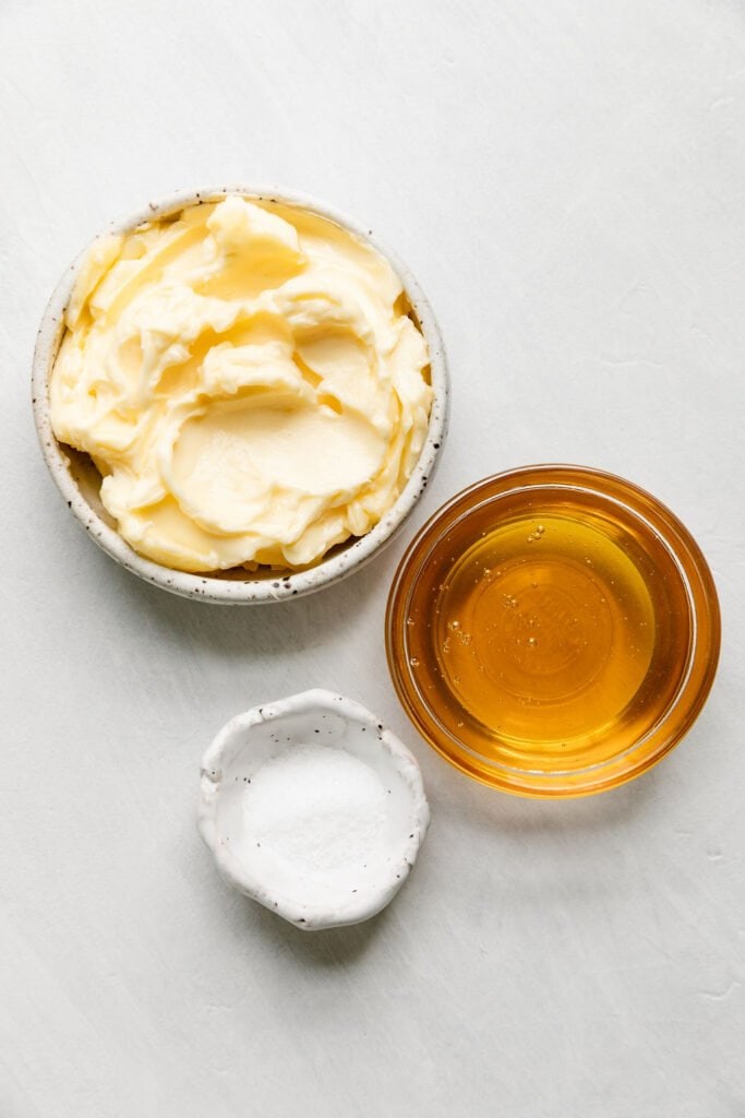 All ingredients for honey butter in small bowls.