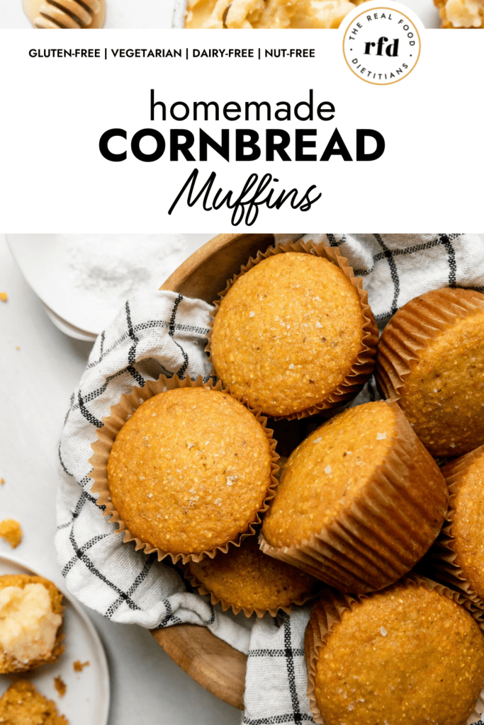 A dishtowel lined wooden bowl filled with homemade cornbread muffins.
