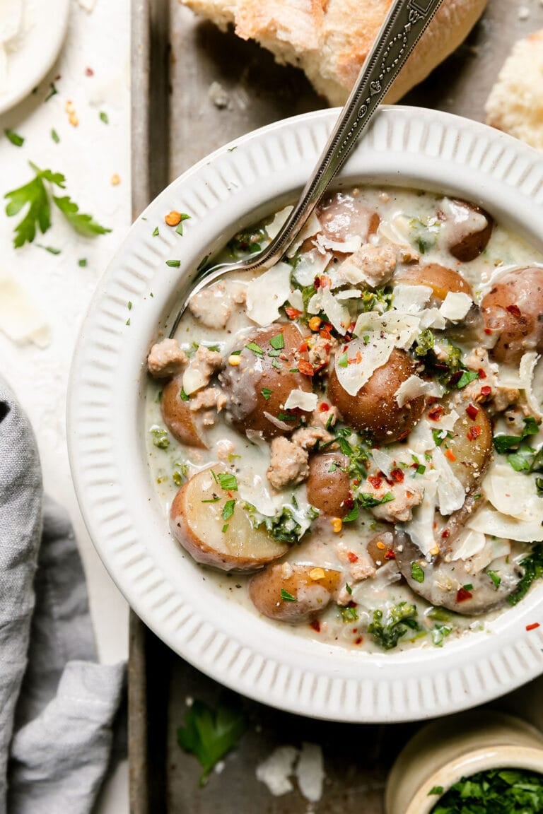 slow cooker zuppa toscana in a white bowl