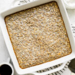 Overhead view protein baked oatmeal in white baking dish.