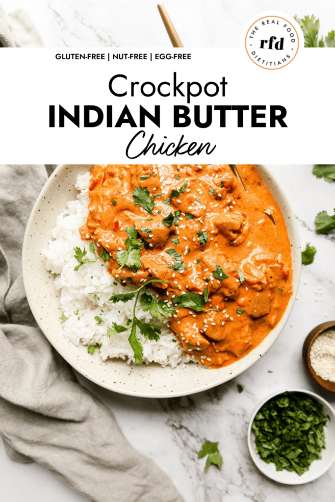 Serving of creamy butter chicken in sauce served over white rice in stone bowl