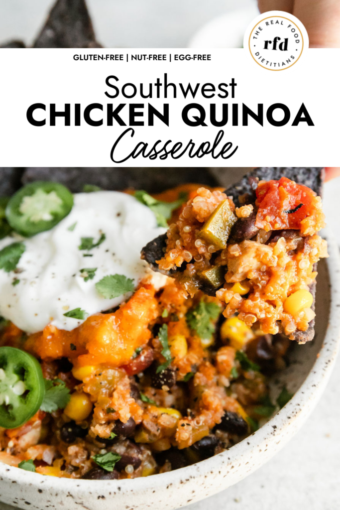 A blue tortilla chip scooping up a small amount of Southwest chicken quinoa casserole from a 