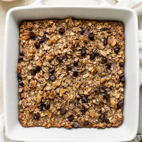 Overhead view banana chocolate chip baked oatmeal in white baking dish