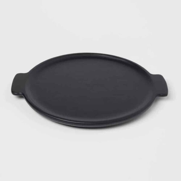 Black round platter with black handles against white background.