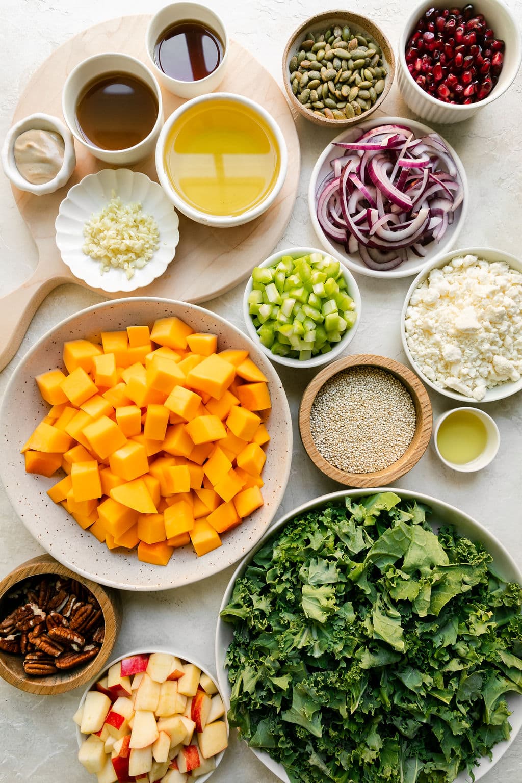 All ingredients for Harvest Salad with Quinoa arranged in small bowls