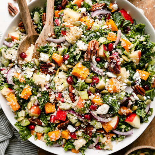 Overhead view harvest quinoa salad with butternut squash in white serving bowl.