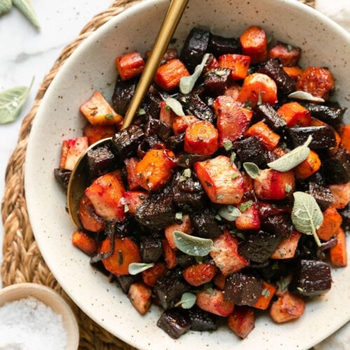 Overhead view shallow bowl filled with honey sage roasted root vegetables