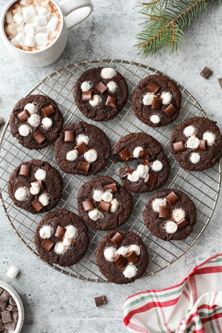 Round wire rack filled with Mexican Hot Chocolate Cookies topped with marshmallows and chocolate chunks.