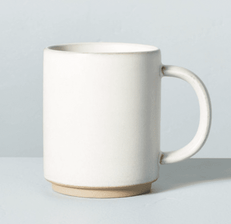 Single stoneware mug on light blue background.