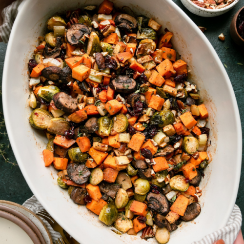 A white serving bowl filled with sweet potato unstuffing.
