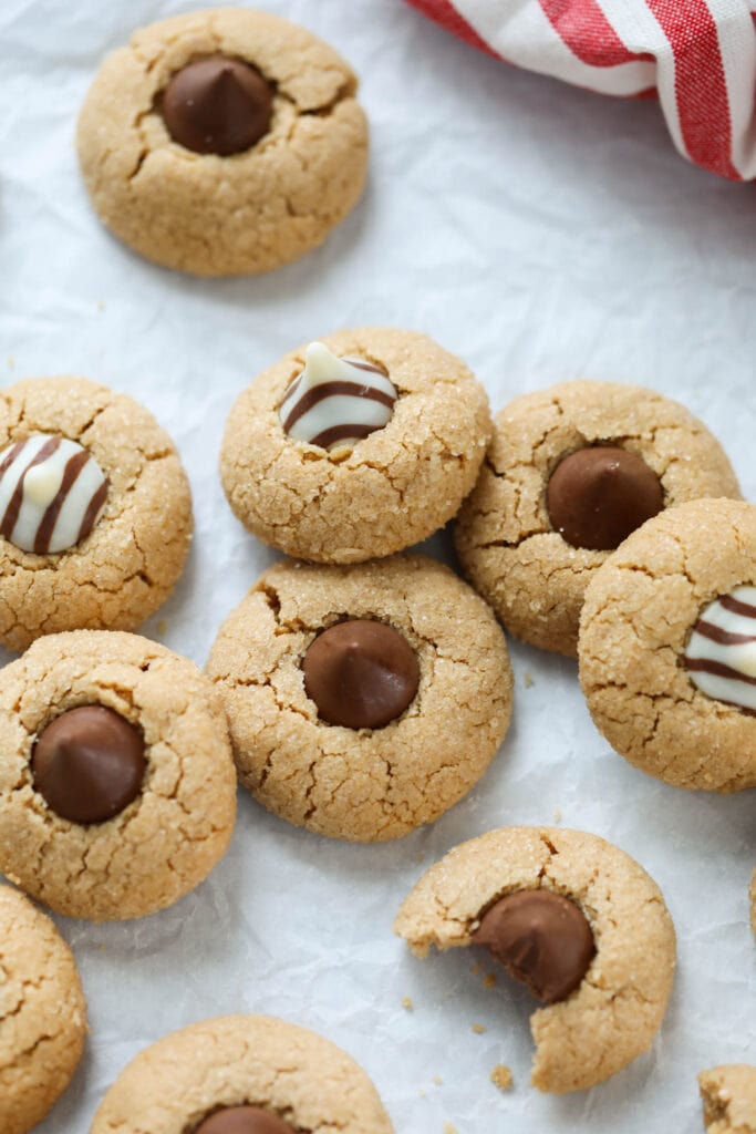 Peanut butter blossoms with chocolate kisses and white chocolate kisses on top.