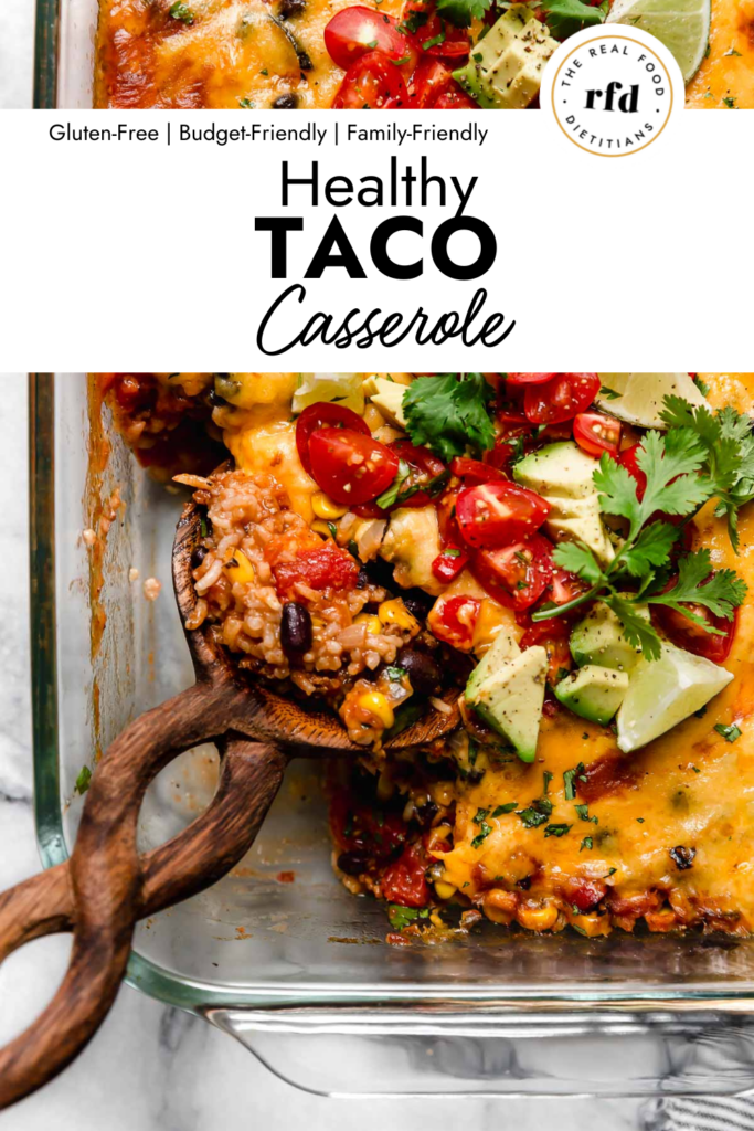 A twisted handle wooden spoon scooping up serving of healthy taco casserole from baking dish.