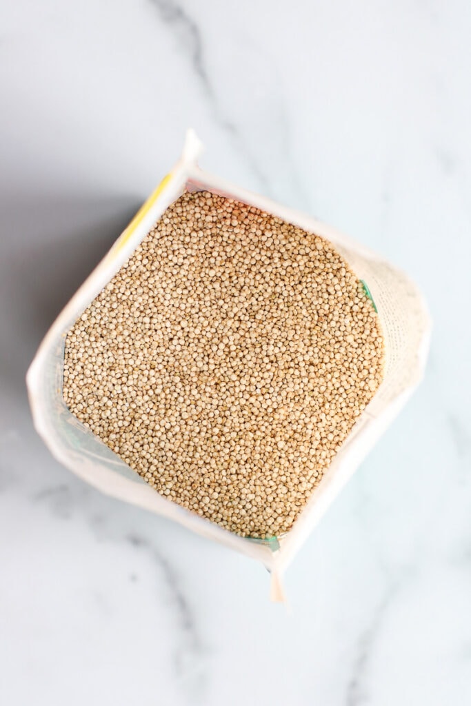 Looking into open bag of uncooked quinoa