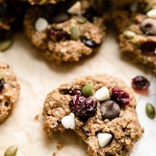 A trail mix breakfast cookie with bite taken out on counter.