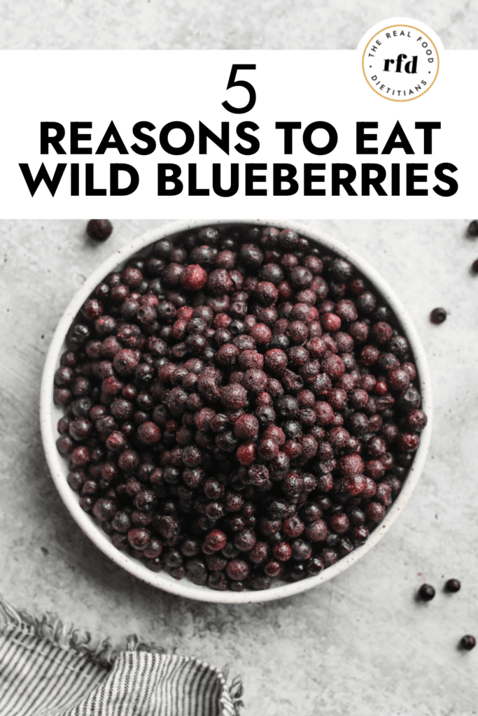 Overhead view stone bowl filled with wild blueberries