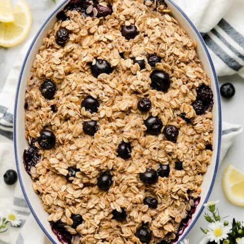 Overhead view oval baking dish with blueberry lemon baked oatmeal.