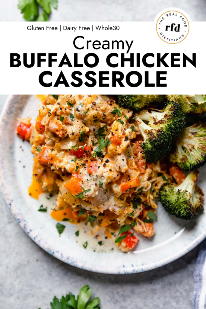 Overhead view creamy buffalo chicken casserole serving on plate with roasted broccoli.