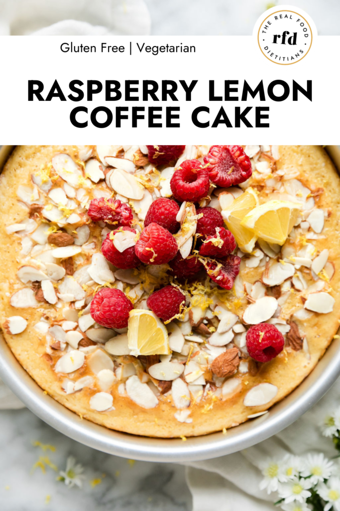 Close up view raspberry lemon coffee cake topped with almonds, raspberries, lemon zest.