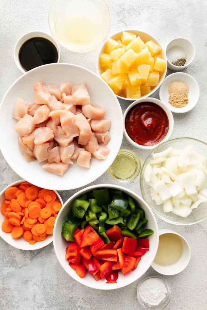 All ingredients for sweet and sour chicken arranged together in small bowls.