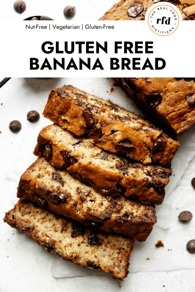 Several thick slices banana bread with melty chocolate chips cut from loaf on white parchment paper.