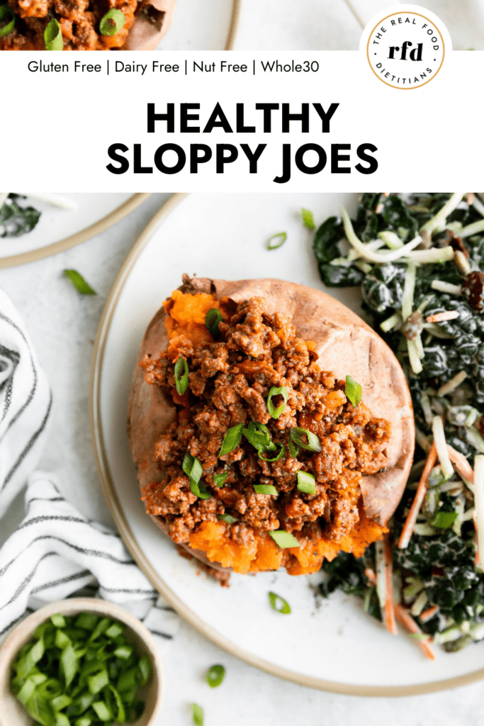 Sloppy joe stuffed sweet potato on plate with side salad