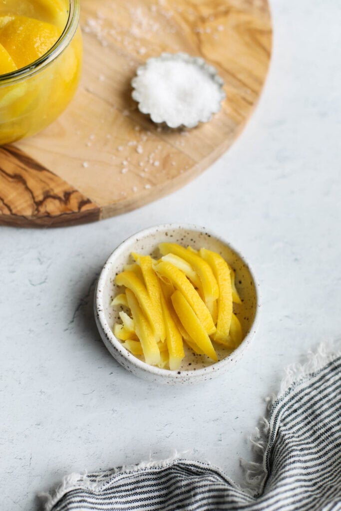 A small dish of sliced preserved lemon rinds ready to be incorporated into a salad or dish.