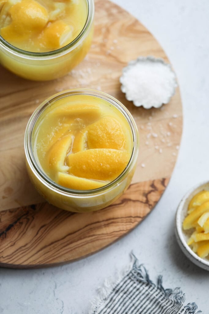 a top view of preserved lemons in a glass jar