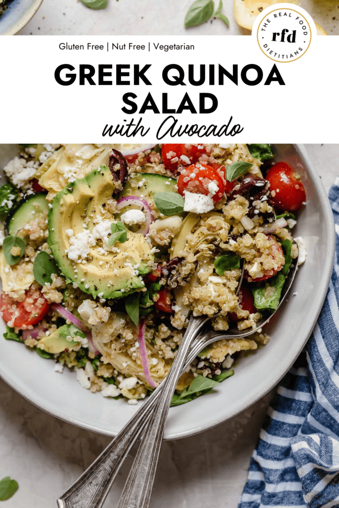 Overhead view stone bowl filled with Greek quinoa salad with feta cheese, kalamata olives and tomatoes