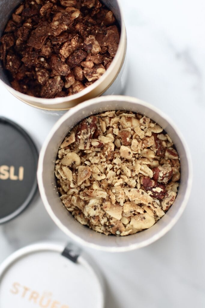 Looking into round containers of Struesli filled with grain-free granola.