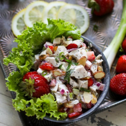 Strawberry Chicken Salad served over lettuce leaves in bowl