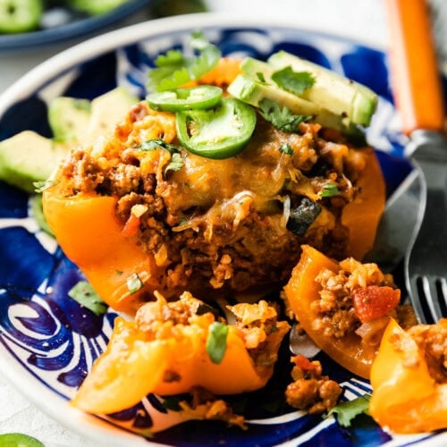 A delicious plated stuffed pepper cut open to show the ground meat filling.