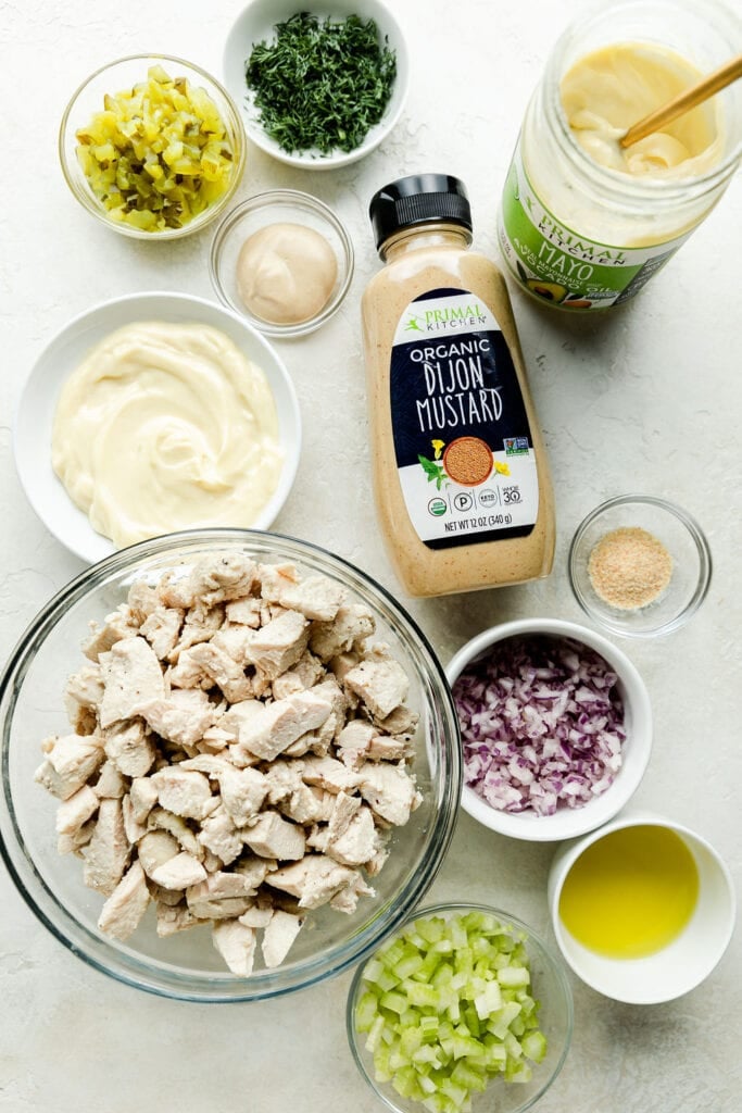 All ingredients for dill pickle chicken salad arranged together in small bowls