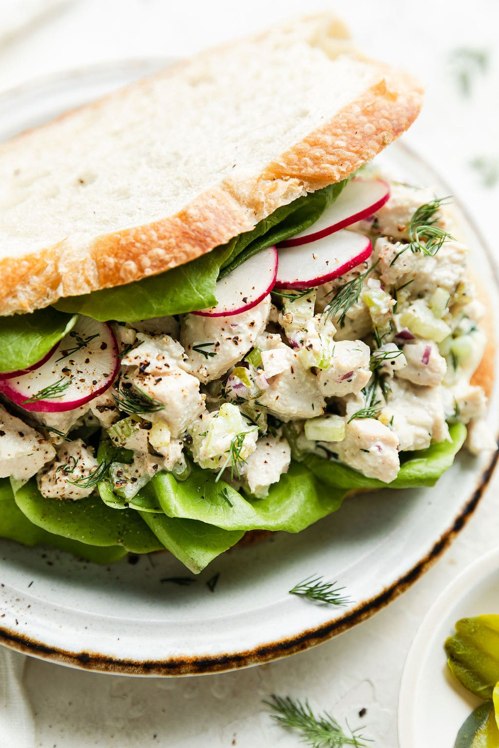 Dill pickle chicken salad served in sandwich with two slices of bread