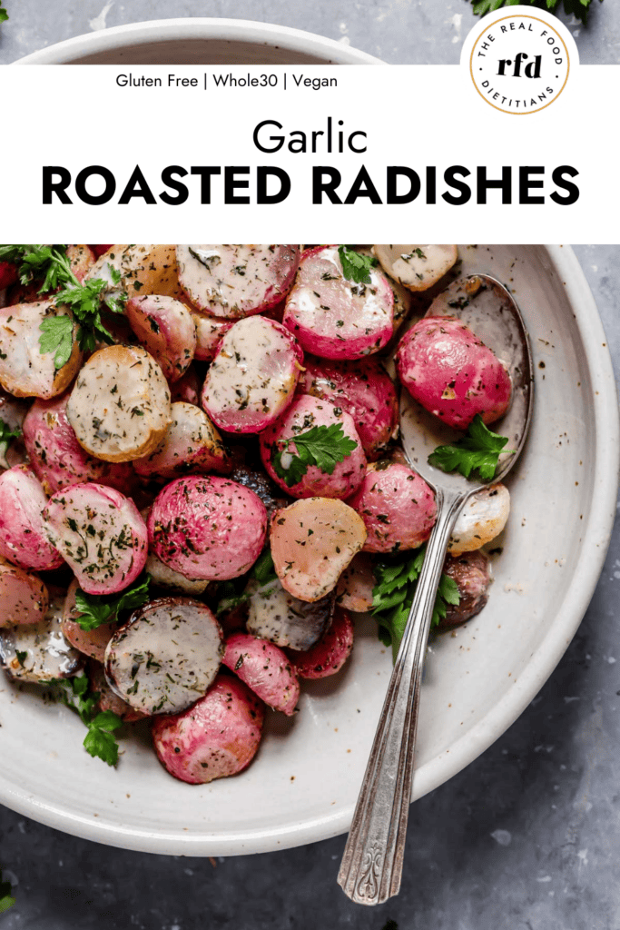 Overhead view garlic roasted radishes coated in ranch dressing served in white stone bowl