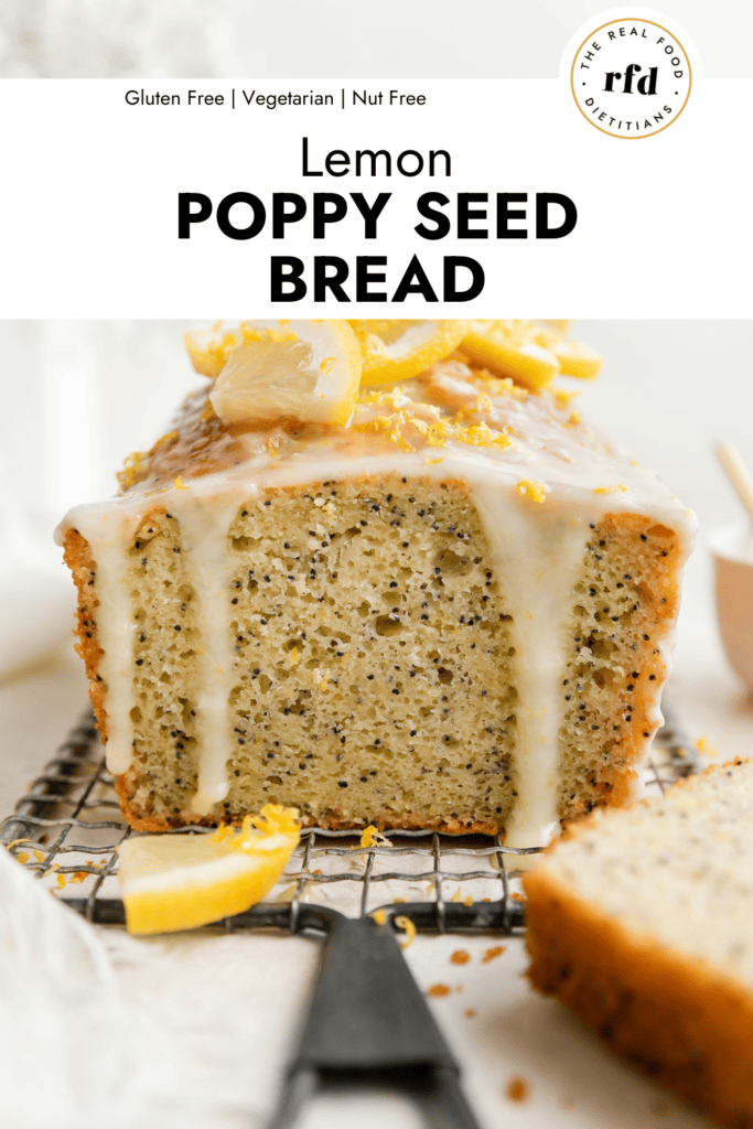 Side view lemon poppy seed bread on wire cooling rack topped with glaze and lemon slices. 