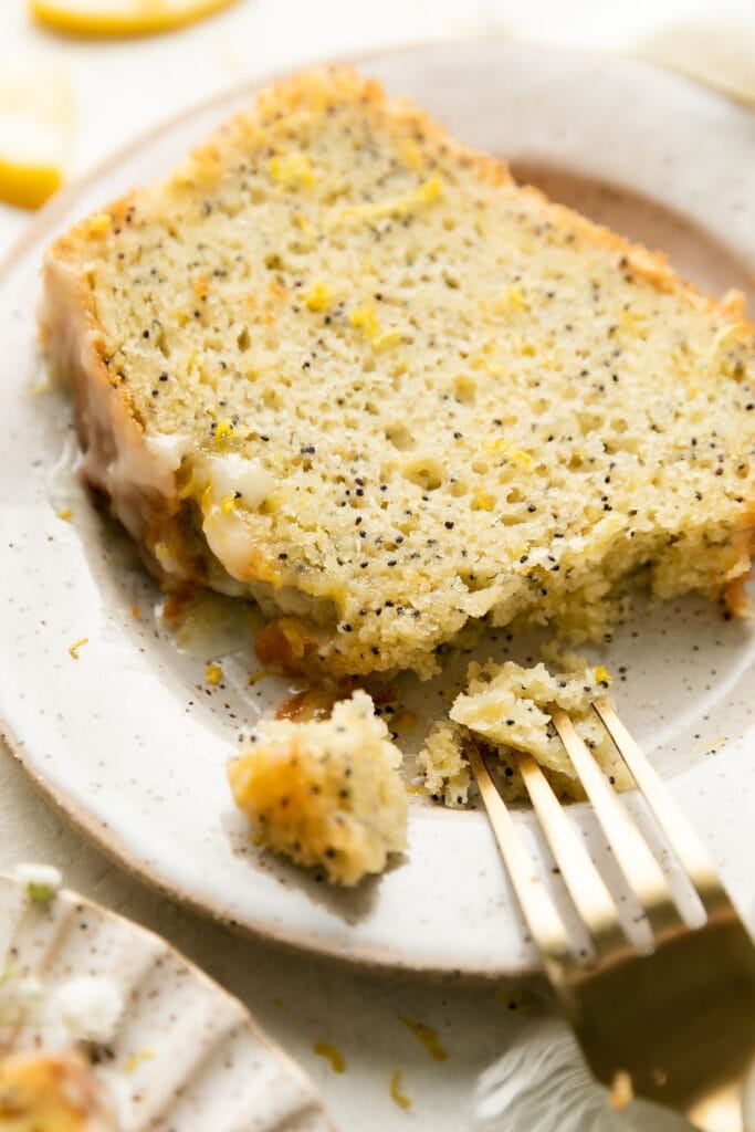 Close up view lemon poppy seed bread slice on stone plate