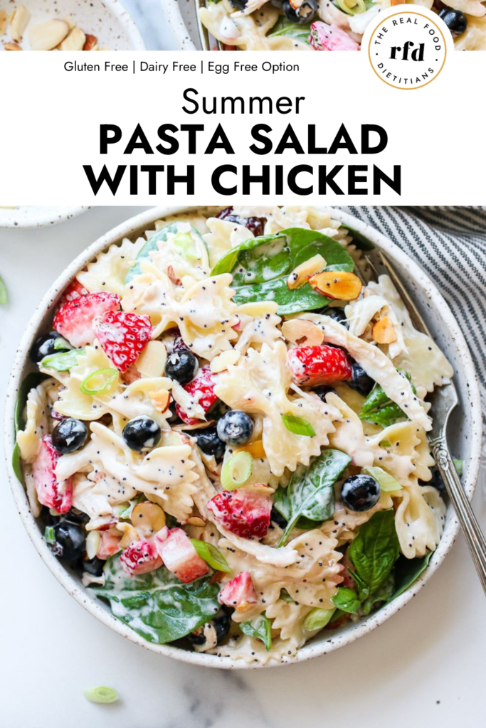 Overhead view stone bowl filled with Summer Pasta Salad with fresh berries and chicken 