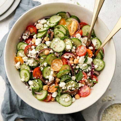 Overhead view white serving bowl filled with Greek cucumber salad