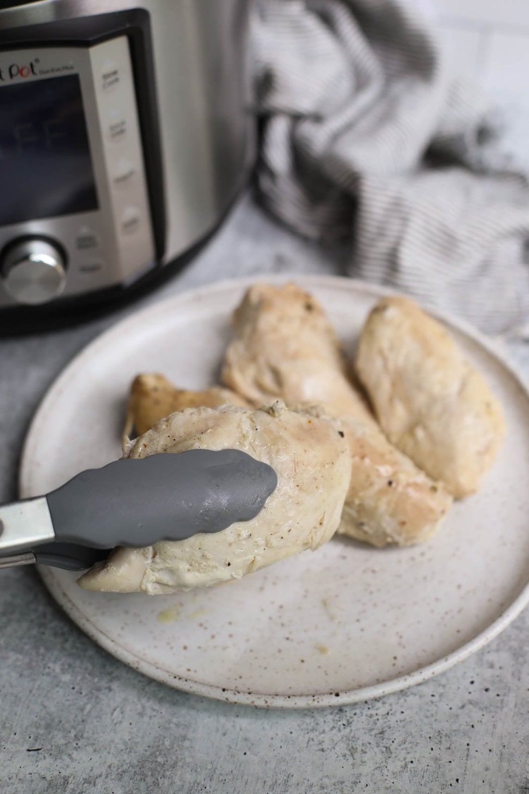 Cooked chicken breast from the Instant Pot, ready to be shredded.