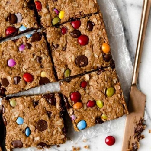 Overhead view monster cookie bars with colorful candy pieces cut into squares