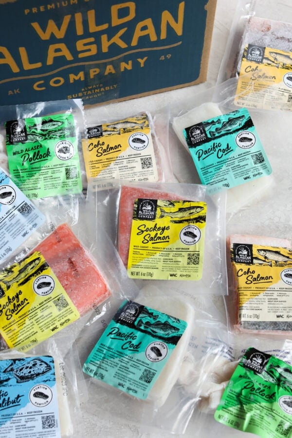 Overhead view of a variety of wild caught salmon options in packaging on a counter top.